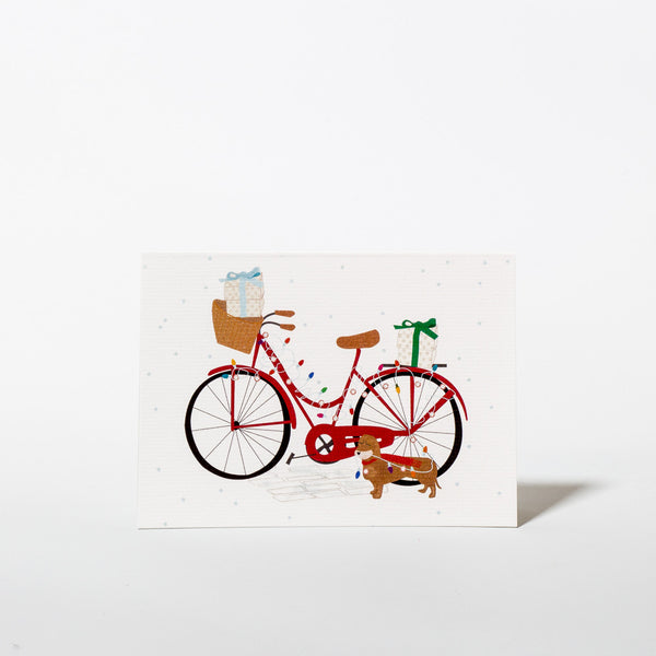 Weihnachtskarte mit festlich geschmücktem Fahrrad und Dackel von Nelly Castro Design.